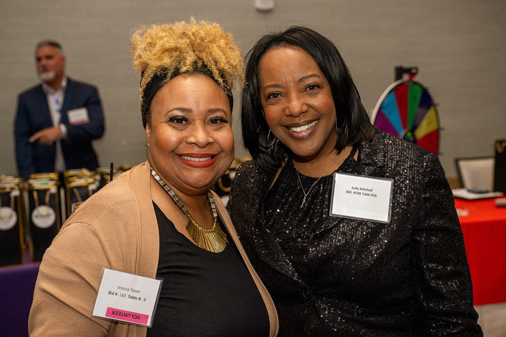 Two women smile for the camera