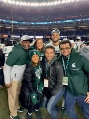 The White family posing for the camera in a football stadium