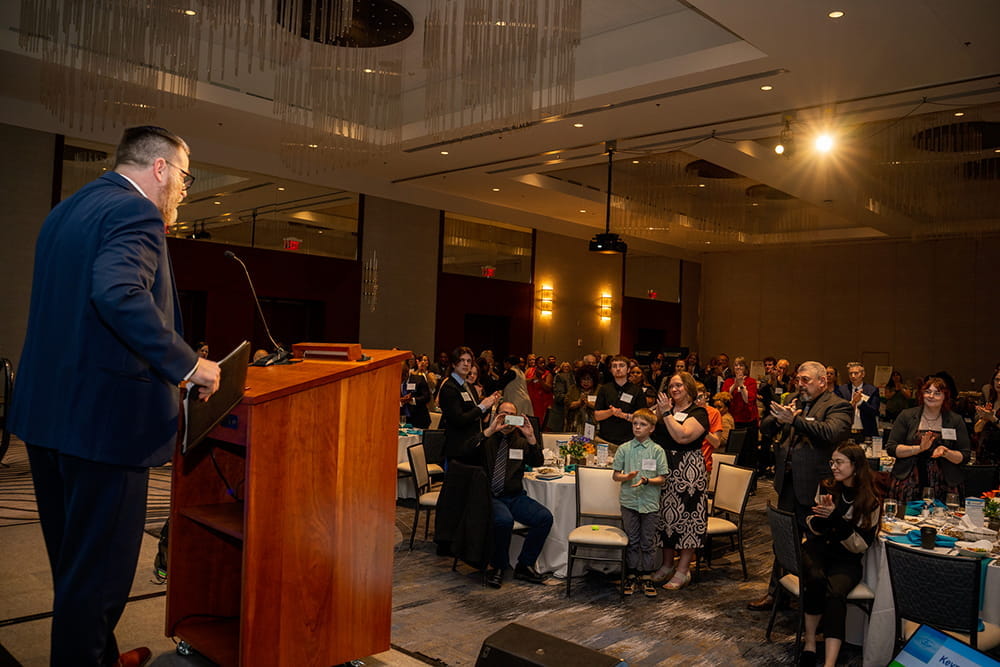 Keynote speaker, Michael Fenning of Lansing Community College, receives a standing ovation for his speech on his experience in foster care.