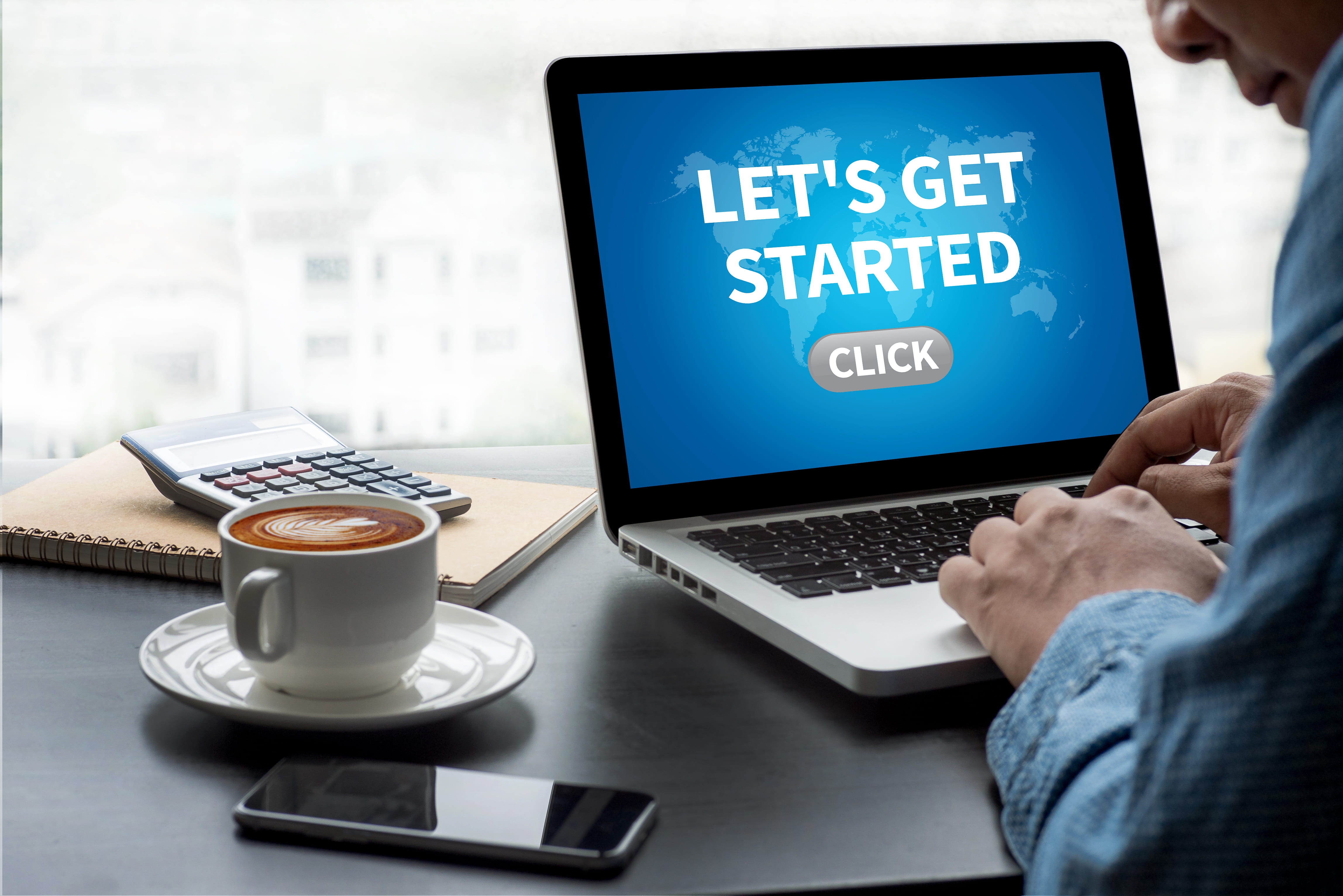 Person looking at laptop with a screen that says Let's get started