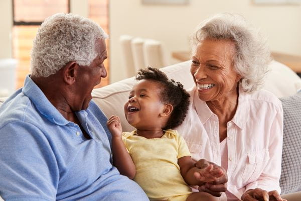 grandparents sitting with grandchild