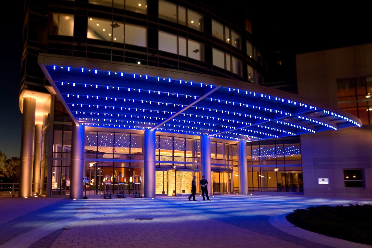 The entrance of the JW Marriott lit up at night