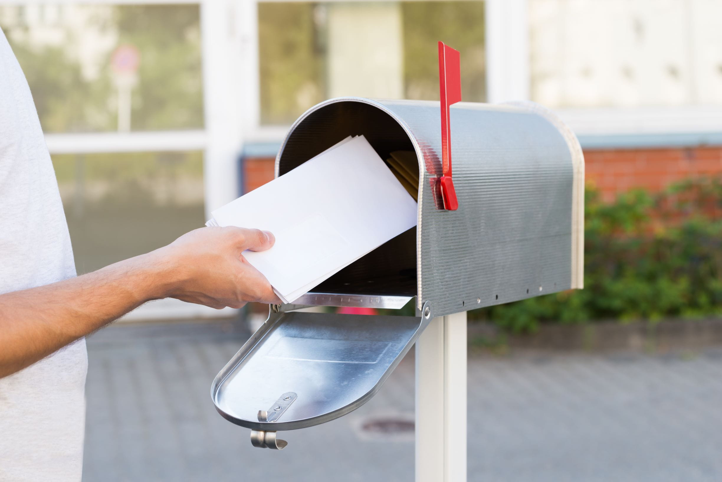 Mailbox with person mailing a letter
