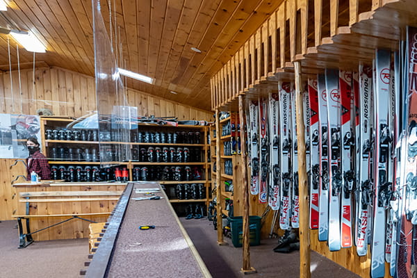 Wall of rental snowboards and skis