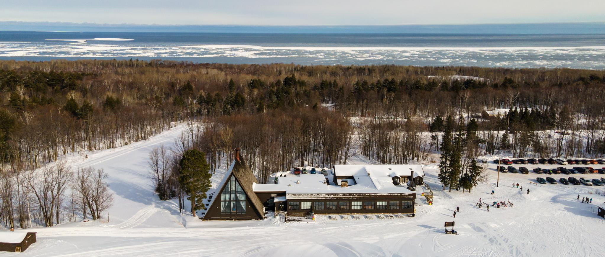 A view of the chalet from the top of the hill with Lake Superior in the background