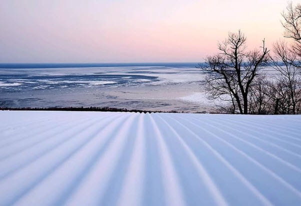 Groomed run overlooking Lake Superior with sunset