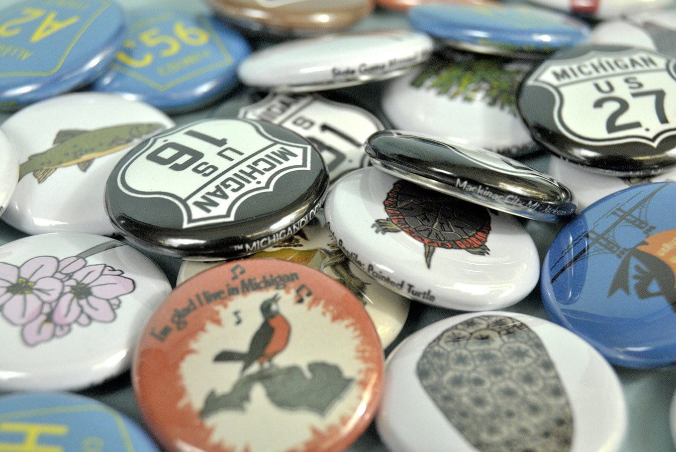 Photo of buttons featuring Michigan facts and symbols.