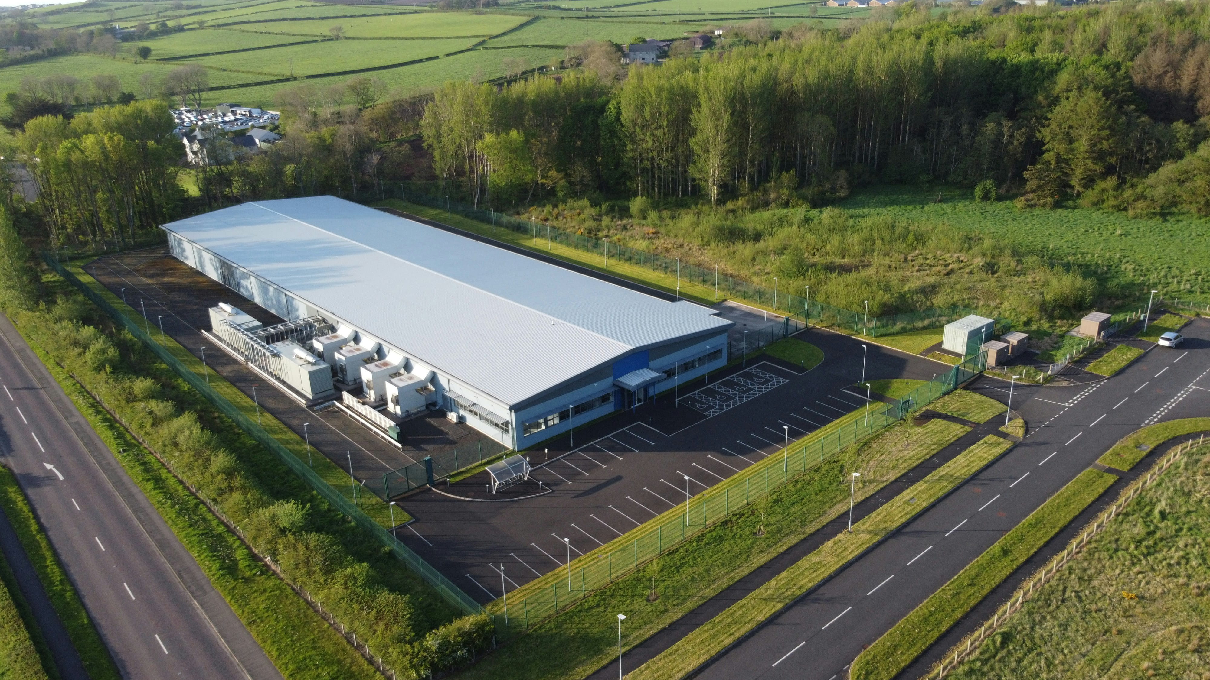 Aerial photo of a building. Photo includes green grass around the building.