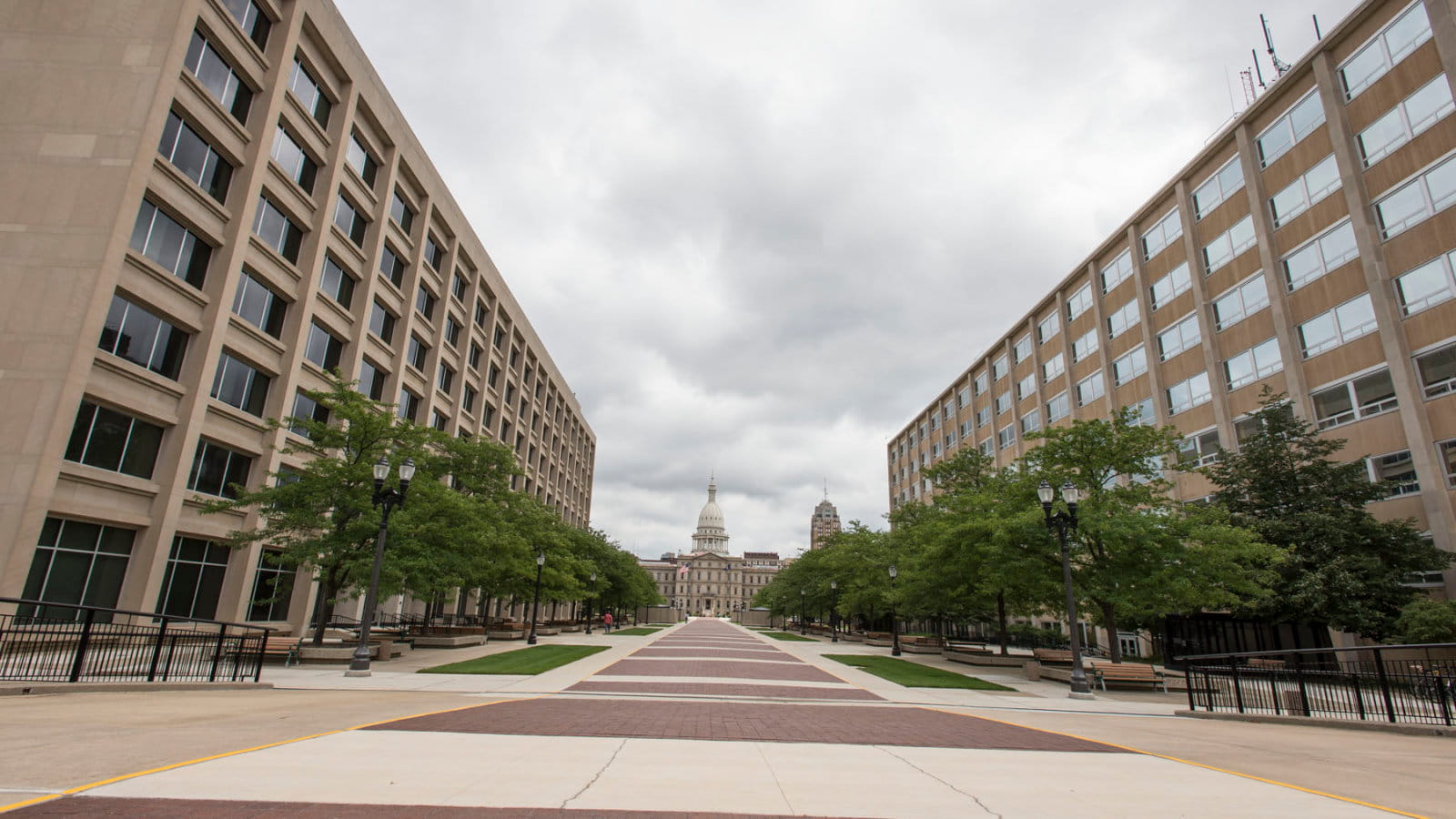 Photo of the Michigan State Capitol with several state buildings in the foreground.