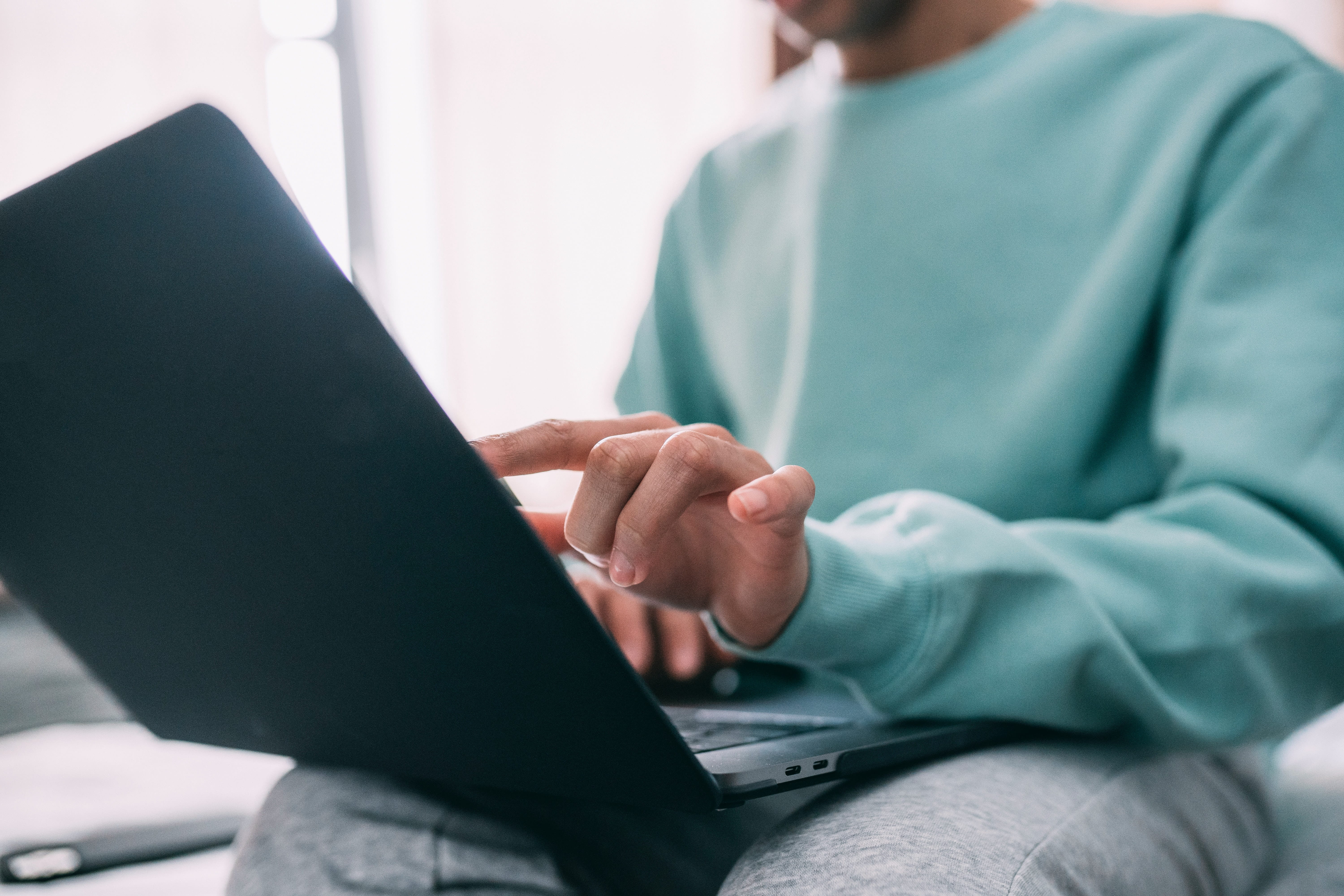 Person typing on a laptop computer.