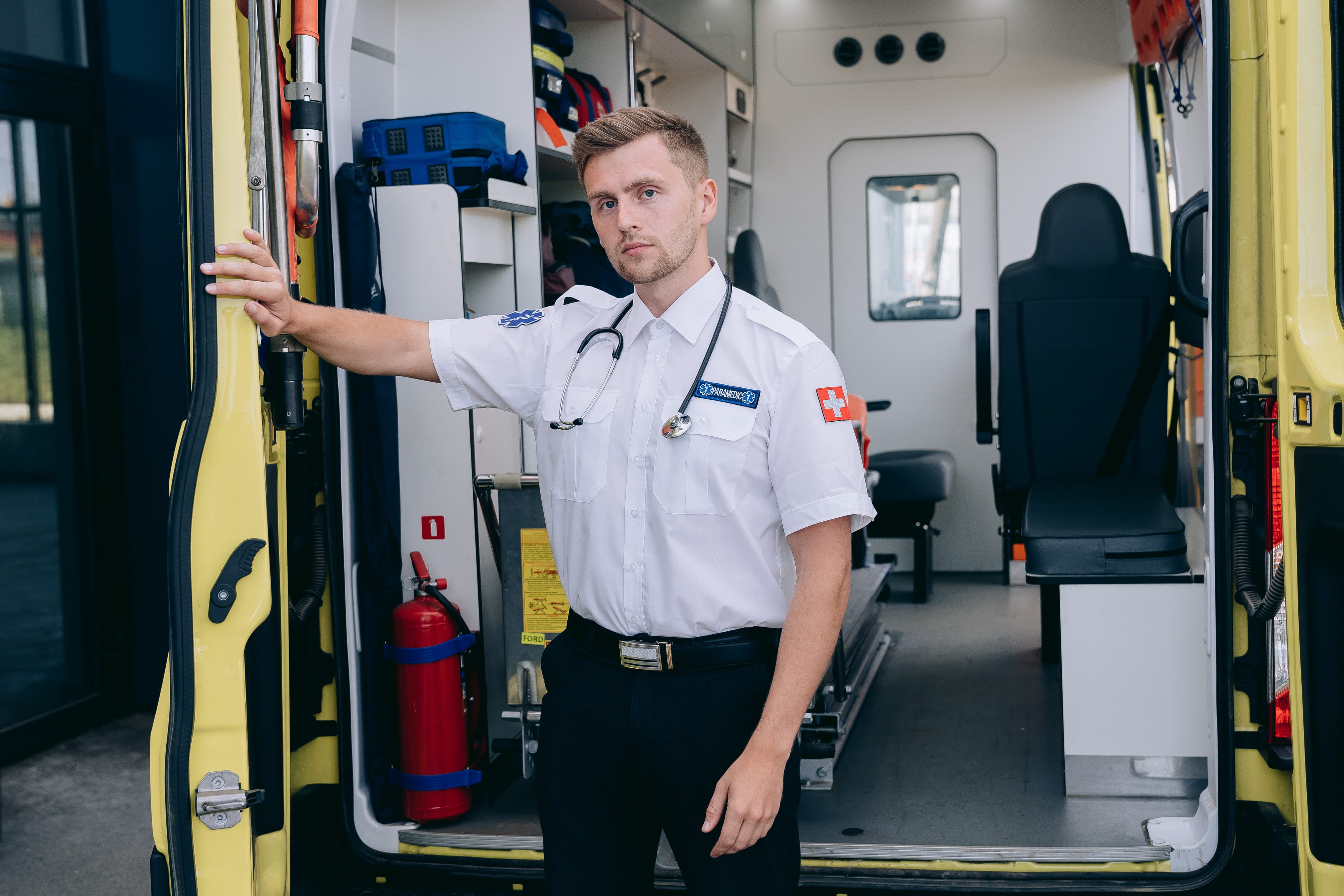 Image of a paramedic standing near an ambulance.