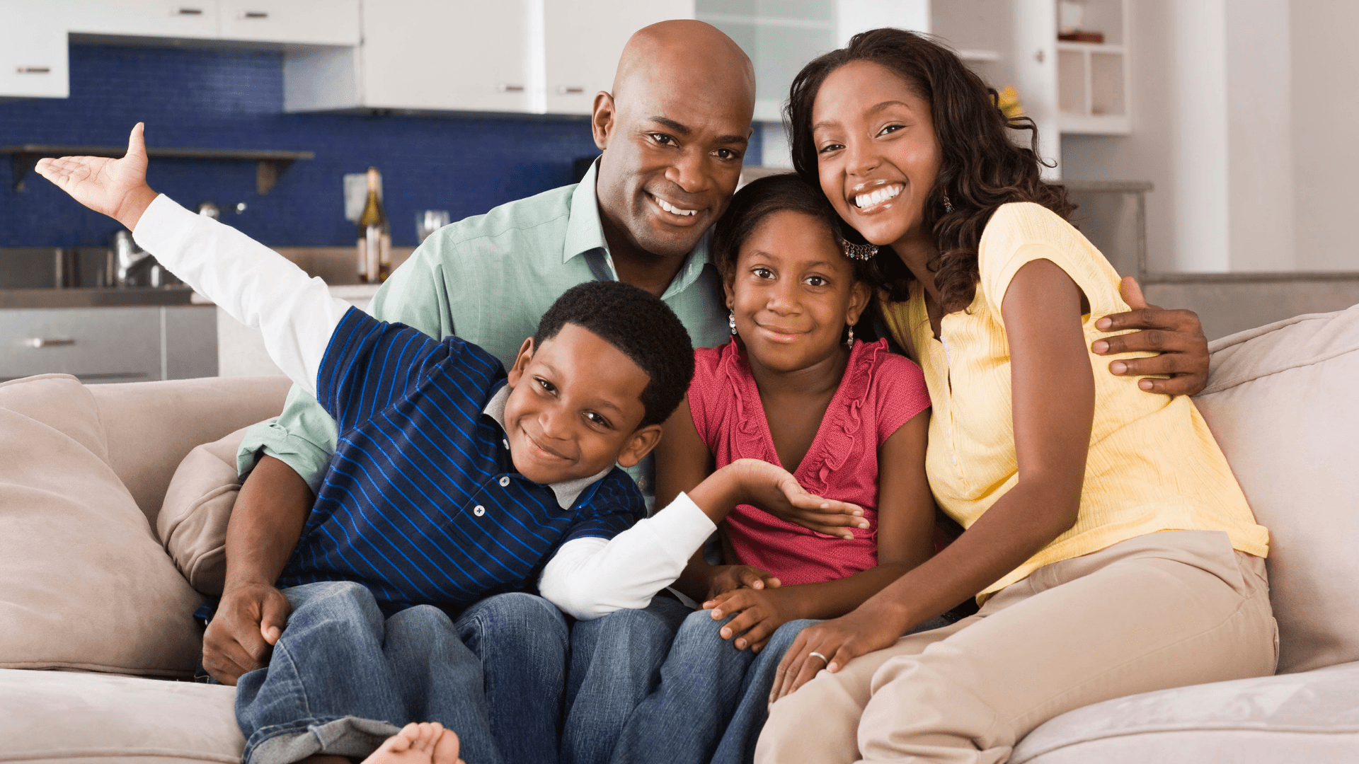 Photo of a family sitting on a couch.