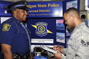 Photo of a service member speaking with a member of the MSP recruitment team.
