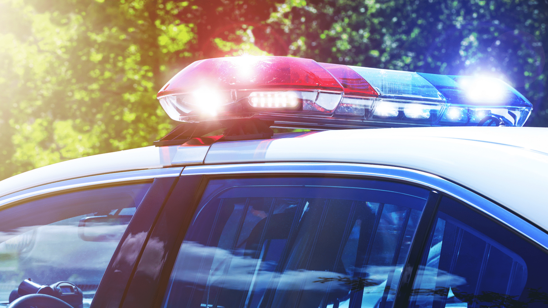 Image a police car with blue and red lights on.