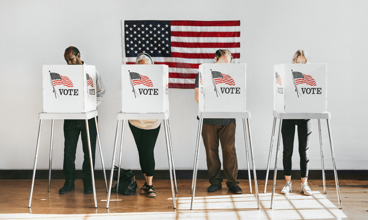 Diverse group of voters standing in voting booths