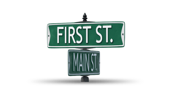 Green street sign showing First St. and Main St.