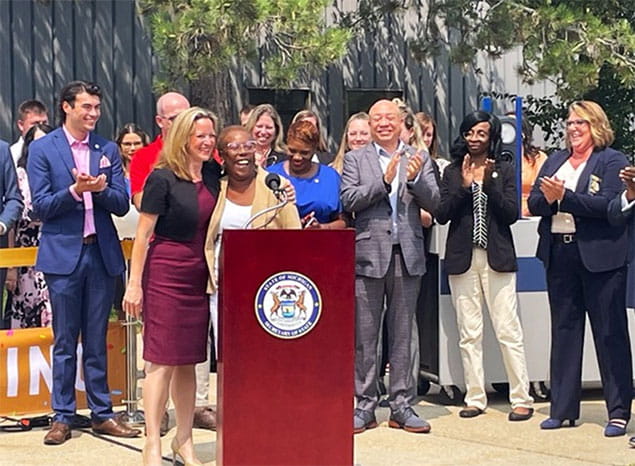Secretary Benson hugs Executive Director Beverly Lewis