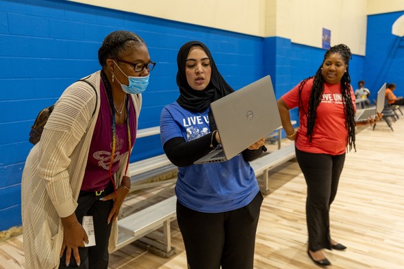 Clinic staff help an attendee at a Road to Restoration clinic in Detroit