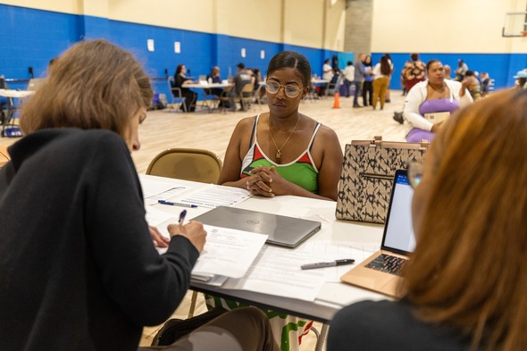 Staff assist an attendee at a clinic in Detroit