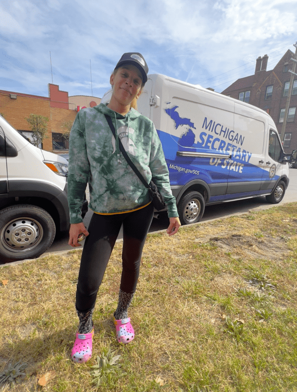 Attendee stands in front of a Mobile Office van