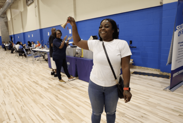 Clinic attendee rings bell after receiving license