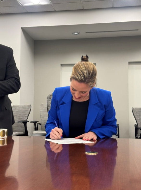 Sec. Benson signs official certificates