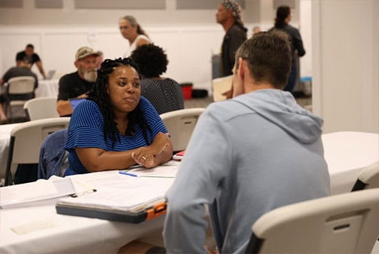 A volunteer attorney speaks with an attendee of the Gaylord clinic