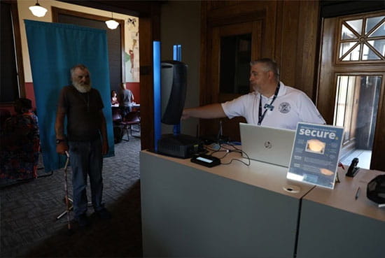 MDOS staff member takes a driver’s license photo of an attendee