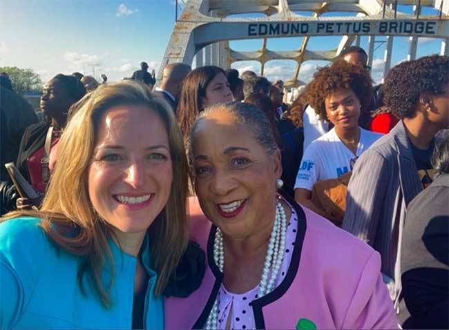 Secretary Benson crosses the Edmund Pettus Bridge in Selma with Sheyann Webb