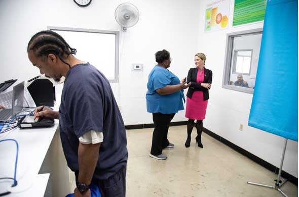Secretary Benson, Deputy Legal Director Khyla Craine and a returning citizen at Parnall Correctional Facility