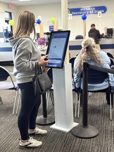 A customer uses the check-in and booking station