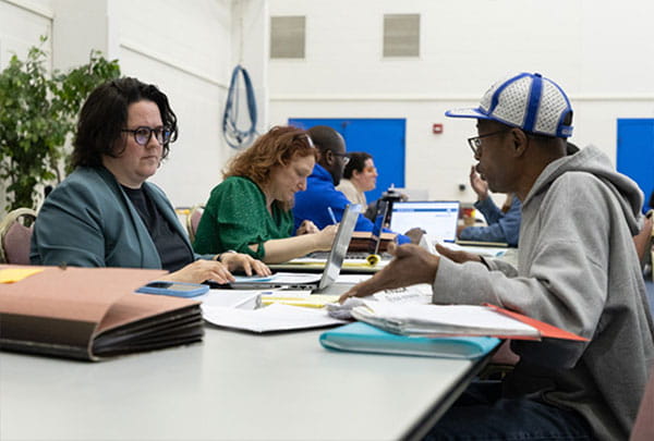 A volunteer Attorney assists an attendee at R2R clinic in Lansing 2025