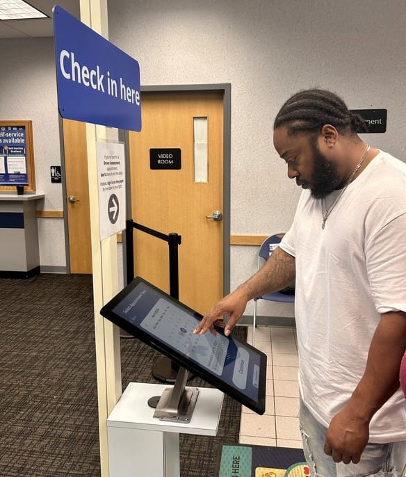 Lester Williams from Kalamazoo uses the new check-in station