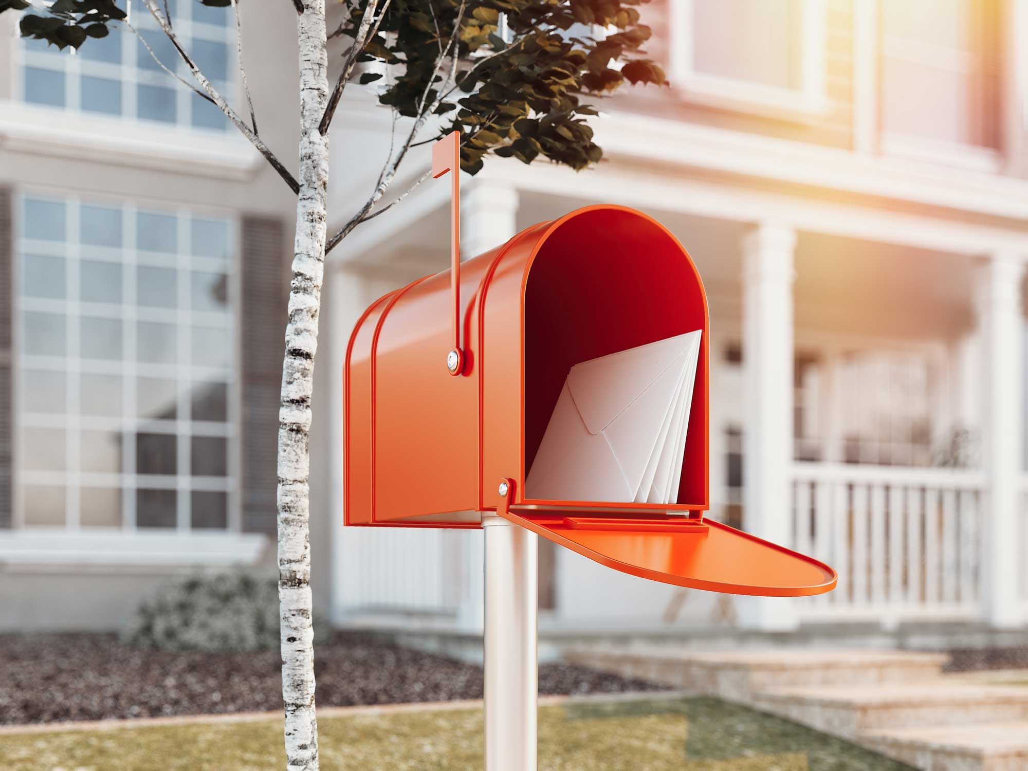 Open red mailbox with a letter inside and flag up.
