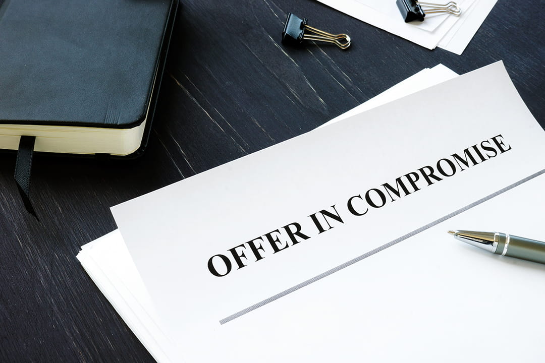 Offer in Compromise printed across the top of a piece of paper.