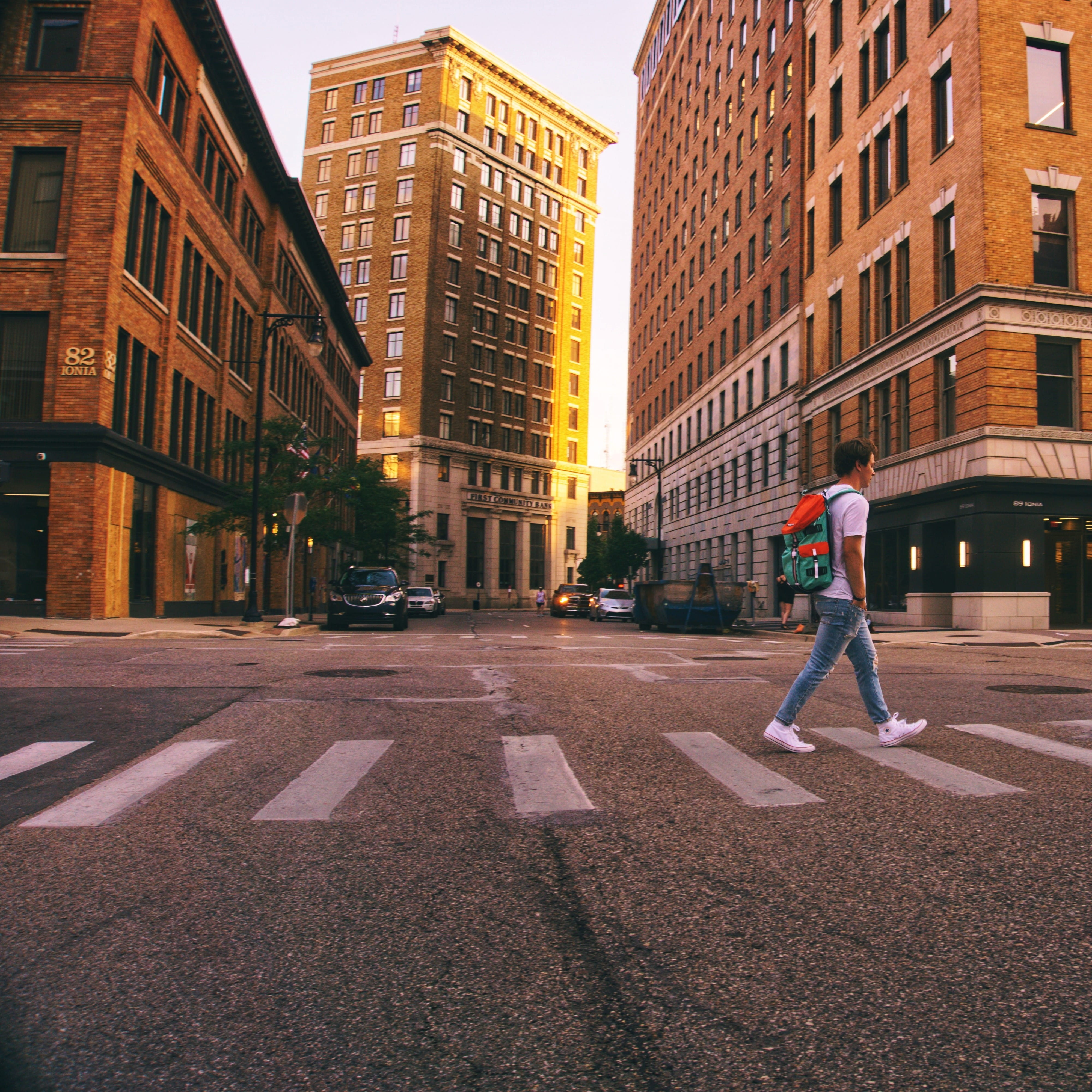 Person walking on a crosswalk in Grand Rapids Michigan.