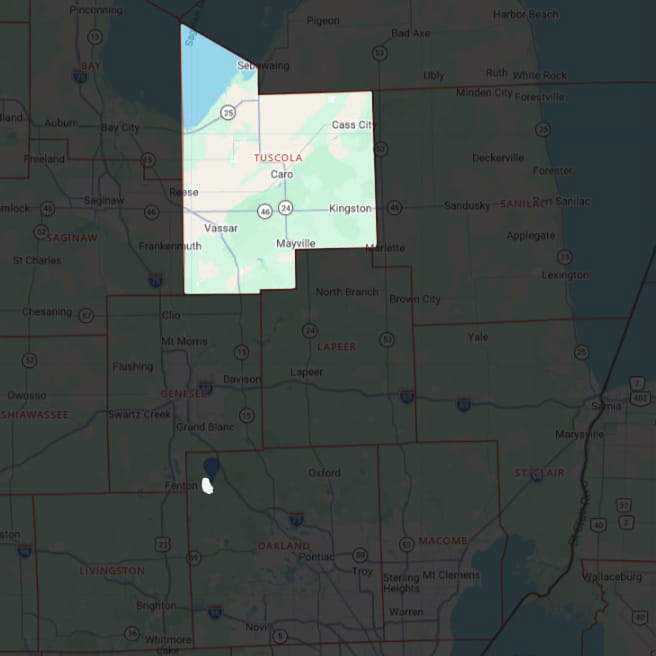 Map highlighting Tuscola County and the Village of Holly in Oakland County.