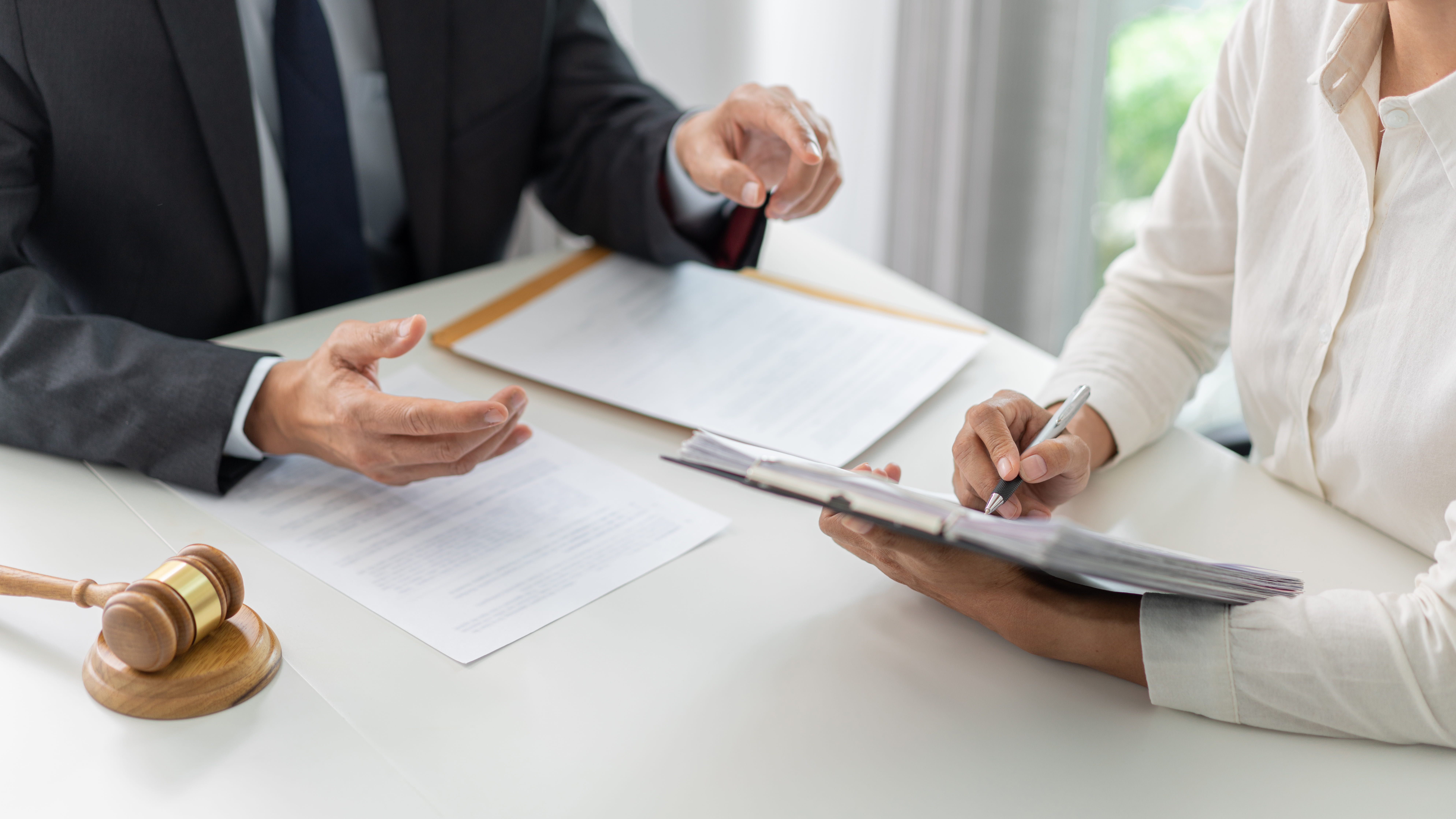 Two people discussing paperwork