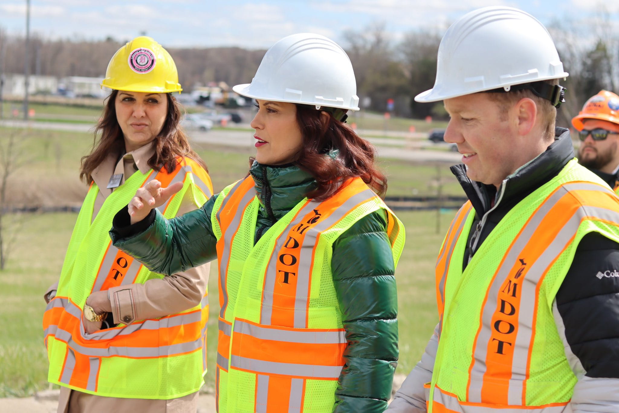 Governor Whitmer stands with hardworking MDOT workers and other officials as she tours a roads project on I-275.
