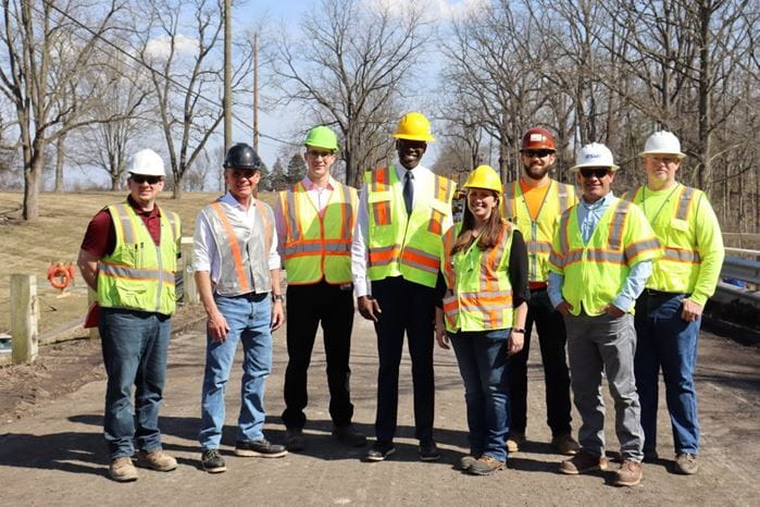 Lt Governor and group pose at Macomb Bridge